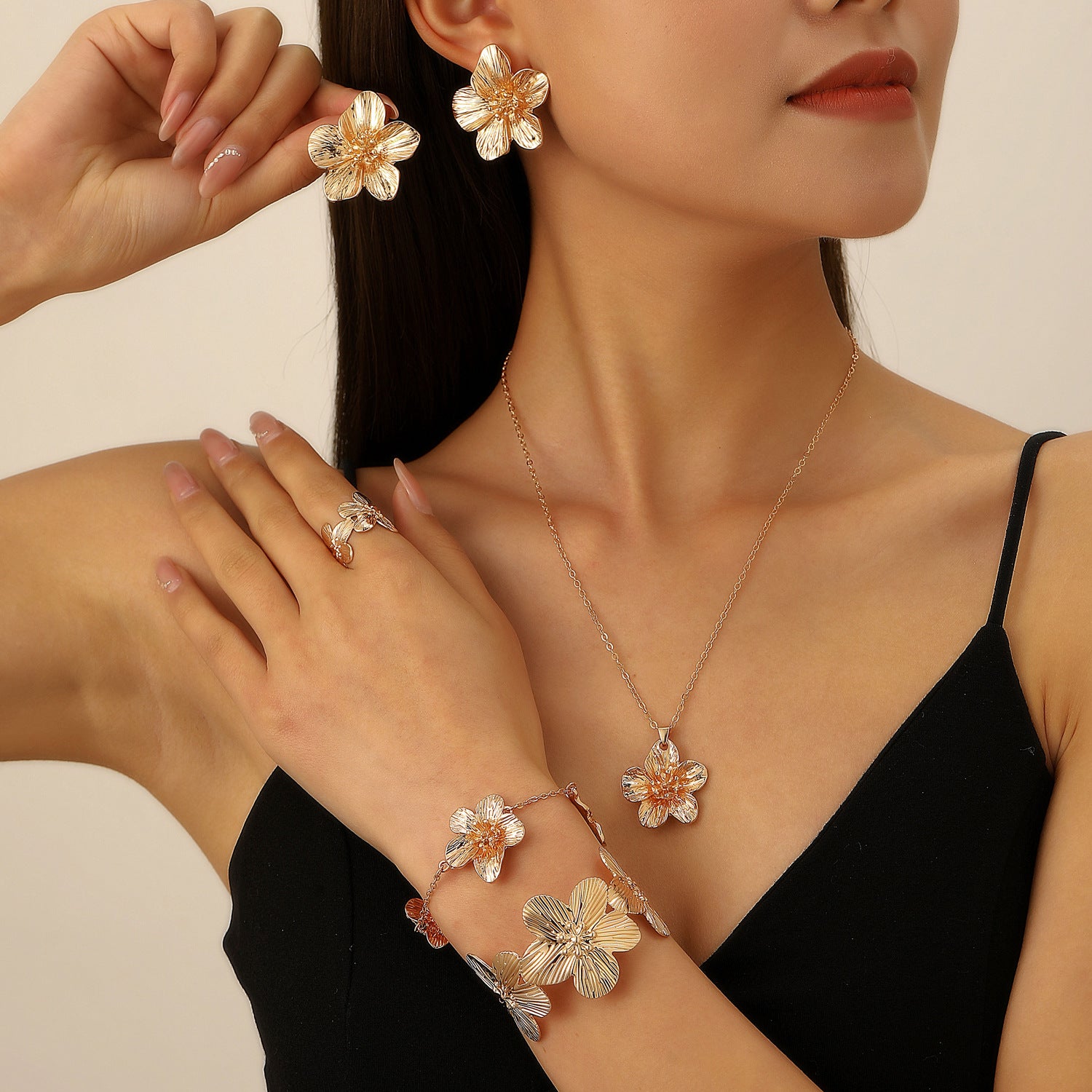 Women's set featuring pleated textured floral earrings, necklace, bracelet, anklet, ring, and bangle.